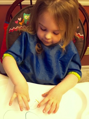 Jet shows me how she made a letter J.